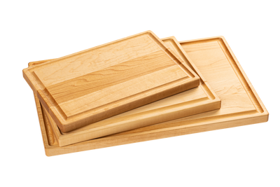 A set of three wooden cutting boards made from maple and cherry, stacked in descending size order.
