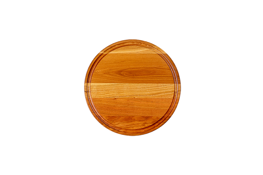 Chop Chop round cherry wood cutting board with a juice groove, premium hardwood board for slicing, chopping, and serving. Made in Quebec