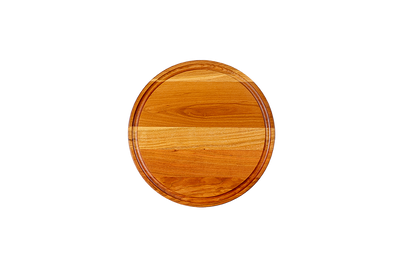 Chop Chop round cherry wood cutting board with a juice groove, premium hardwood board for slicing, chopping, and serving. Made in Quebec